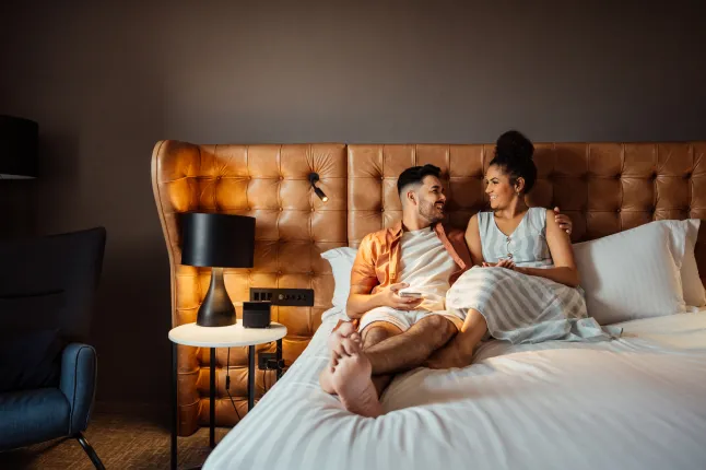 Couple en vacances dans un lit d'hôtel