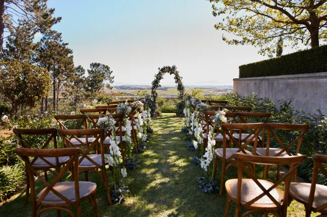 Chaises vides décorées de fleurs disposées près de l'autel de mariage